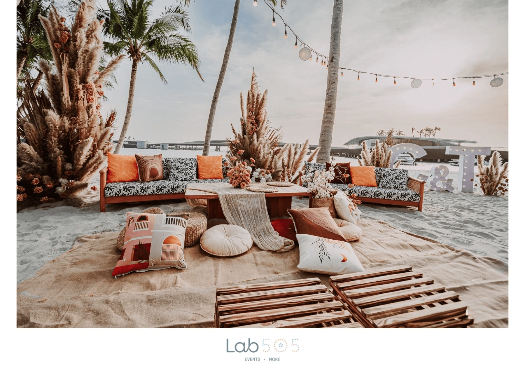 Beachside event lounge with low tables and soft seating