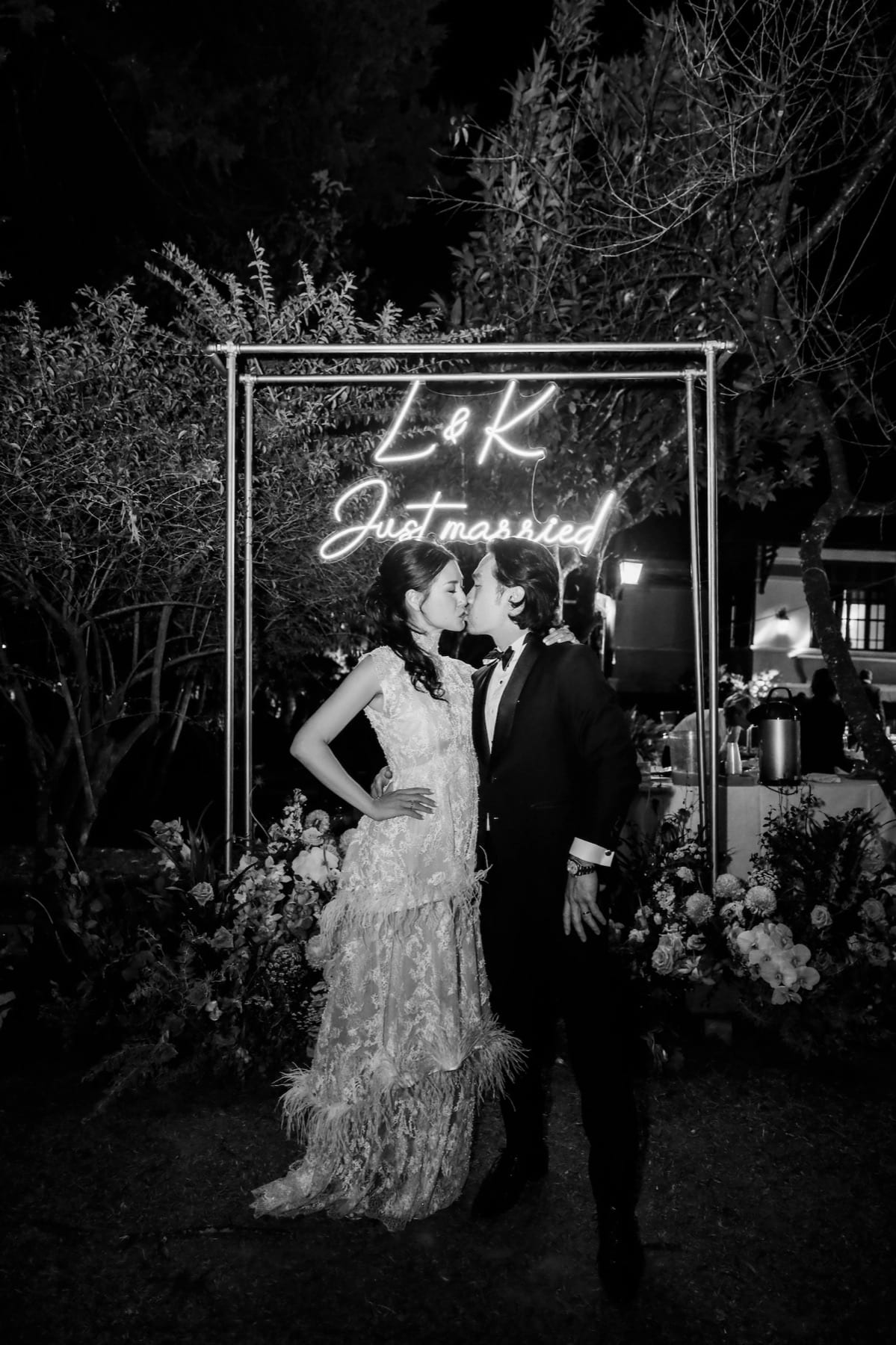 Bride framed by a glowing handwritten light installation