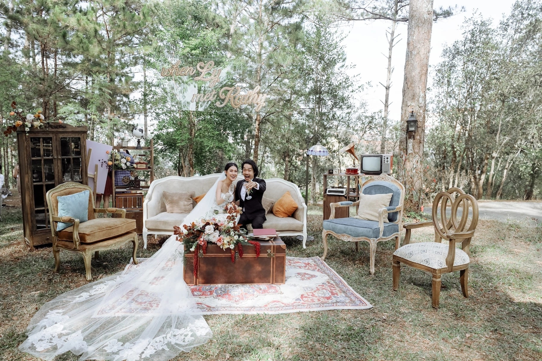 Couple seated in a styled outdoor portrait setting